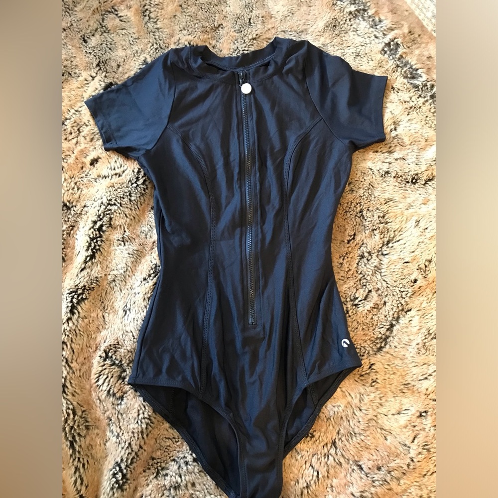 “Bond Girl” look! Flattering! One piece suit in black by next. Like New.